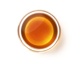 Sesame oil in glass bowl isolated on white background with clipping path. Top view. Flat lay.