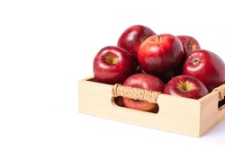 Red apple in wooden box isolated on white background with clipping path.