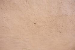 Wall of old adobe house. Mud background and vintage tone. Soft picture