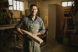 portrait of a professional carpenter in his workshop