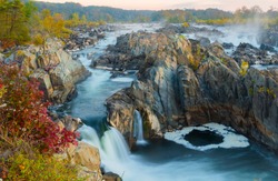 During the fall season Great Falls displays beautiful colors along the ripaians boundaries of the Potomac River near Washington DC. This view is from an overlook at Great Falls Park, VA