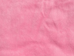 Pink color velvet fabric texture top view. Female blog rose velour tactile background. Smooth soft fluffy velvety satin cloth metallic shiny material.Elegant luxury wallpaper for girls fashion website