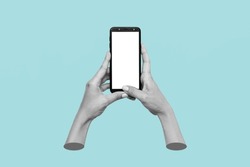 Mobile phone with white screen in female hands isolated on blue background. Blank with an empty copy space. Mockup of a smartphone. 3d trendy collage in magazine style. Contemporary art. Modern design