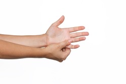 Cropped shot of a young woman holding palm's fingers in her hand isolated on a white background. Numbness of the limbs. Injuries, arm pain, carpal tunnel syndrome, neuralgia. Medical concept