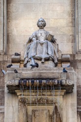 fragment of the monument dedicated to the writer Cervantes in Madrid whit Dulcinea from an pigeons Toboso