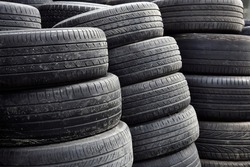 Selective focus of used car tires pile.