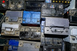 top view of many used car batteries waiting to be recycled in an environmentally harmful scrap yard