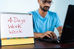 focus on calender, Concept of four or 4 days work week showing by young man working in background and shows calendar