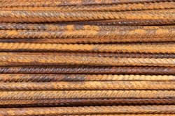 Background and rusty iron reinforcement rods. Red orange color of iron oxide on reinforcement bars