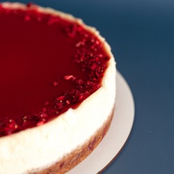 Red and white mousse cake, cheesecake on blue background. stylish food concept