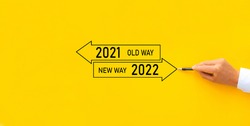 Improvement and change management. Businessman draw arrow panel with Old Way 2021 and New way of the  year 2022.