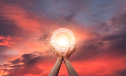 Zodiac signs inside of horoscope circle in woman hand at sunset. Astrology and horoscopes.
