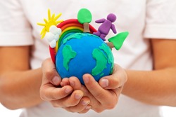 Life on earth - environment and ecology concept with clay earth globe in child hands