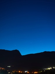 dark blue starry sky with mountain landscape. dark mountains. blue night sky. night landscape