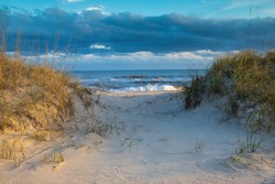 Background of a sandy beach path through the dunes to the beach in Hatteras, North Carolina on the outer banks.