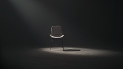 A black chair on dark background, low key and spotlight.