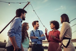 Cropped shot of a group of friends having a conversation on a boat