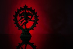 Silhouette of Indian Dancing God Shiva Nadarajah (Nataraja) Statue on red background. Religion or yoga concept