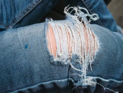 Children wear jeans.Trousers tear until the yarn.