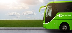 Electric tourist bus on a background of green field