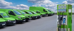 Electric vehicles charging station on a background of a row of vans. Green transportation concept