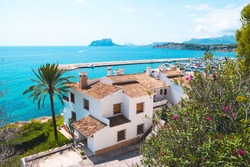 Traditional white houses with unspoiled idyllic view of marina, coastline and Mediterranean Sea in Moraira, Costa Blanca, Spain