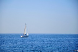 A sailing boat sailing into the sea.