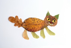autumn nature craft for kids, cat made of leaf, top view, activity for children