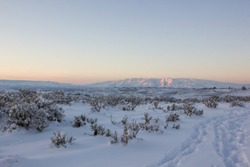 Pastel sundown over Mt Clemens in Naches, Washington across a snowy canyon. 