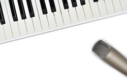Top view of microphone and synthesizer keyboard on white background. Professional studio gear for voice recording and play music.