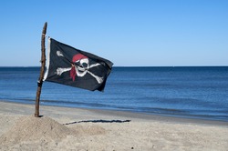Jolly Roger Pirate flag blowing in the wind.