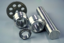 Steel turning and milling parts and gears on a dark background. Metal production