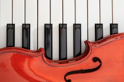 classical violin on white and black piano keys close-up background