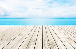Wooden pier with blue sea and sky background 