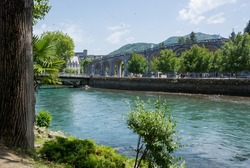 View of the river Gave de Pau in Lourdes, France. The Sanctuary at Lourdes. 