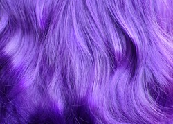 Vivid violet wavy hair texture, close up, salon advertising, dye, purple hair