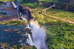 Rainbow over Victoria Falls in Zimbabwe, sunny day in Africa