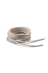 Subject shot of milk-white shoe strings with thin tips. The shoe laces are rolled into a coil and isolated on the white background.