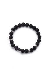 Detailed shot of black bracelet made of lava stone beads and decorated with silver charms and black stone cross. The stylish bracelet is isolated on the white background. 