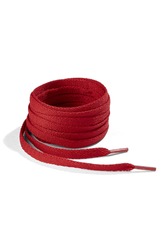 Subject shot of red shoe strings with thin tips. Flat shoe laces are rolled into coil and isolated on the white background.
