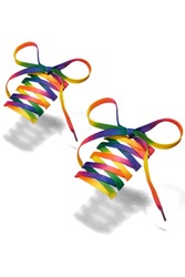 Subject shot of bright shoe strings with rainbow print. Flat shoe laces with thin tips are tied in bows and hanging in the air on the white background. 