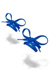 Subject shot of blue shoe strings with thin tips. Flat shoe laces are tied in bows and hanging in the air on the white background. 