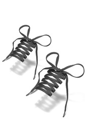 Subject shot of gray shoe strings with thin tips. Flat shoe laces are tied in bows and hanging in the air on the white background. 