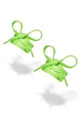 Subject shot of yellow-green shoe strings with thin tips. Flat shoe laces are tied in bows and hanging in the air on the white background. 