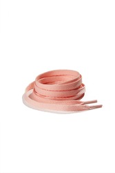 Subject shot of pale pink shoe strings with thin tips. Flat shoe laces are rolled into coil and isolated on the white background.