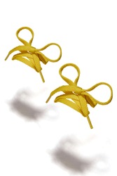 Subject shot of yellow shoe strings with thin tips. Flat shoe laces are tied in bows and hanging in the air on the white background. 