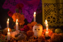 Sugar skull with candles, bread and flowers decoration for the day of the dead altar mexican tradition
