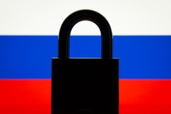 Flag of Russia with black lock in the foreground. Closed country, international isolation concept