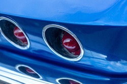 Fragment of a vintage blue car - rear round red lights
