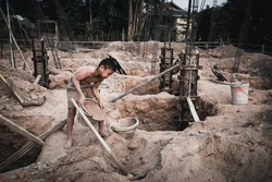 Children who work hard on the construction site, child labor , World Day Against Child Labour concept.